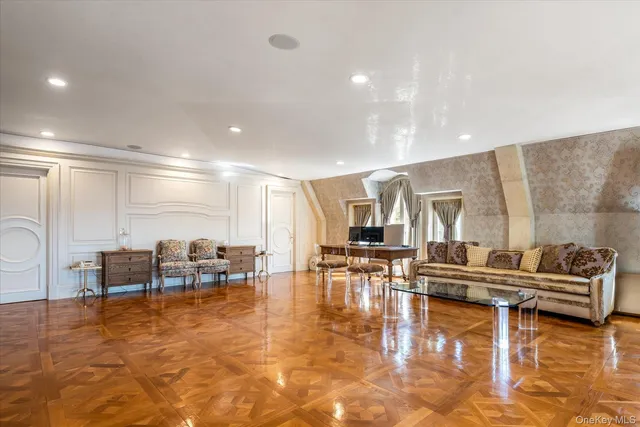 a living room with furniture a wooden floor and chairs