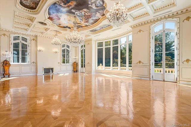 a view of an entryway with a floor to ceiling windows and a chandelier