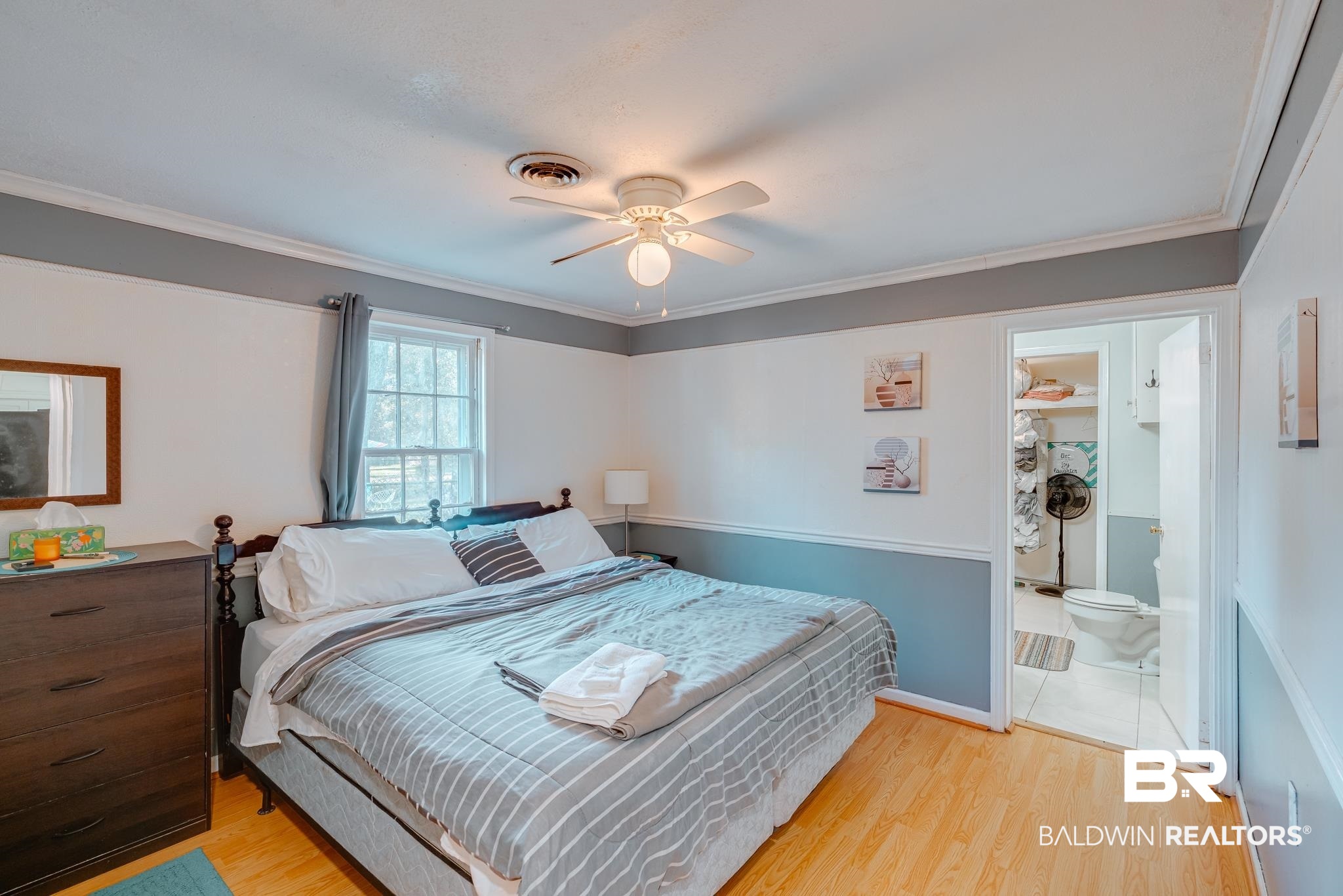 315 Fourth Avenue Chickasaw, AL 36611 - Photo 22 of 28 Bedroom with ensuite bathroom, ornamental molding, visible vents, and light wood-type flooring