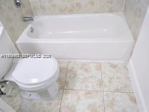 a bathroom with a toilet and a bathtub