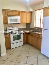 a kitchen with a stove sink and cabinets