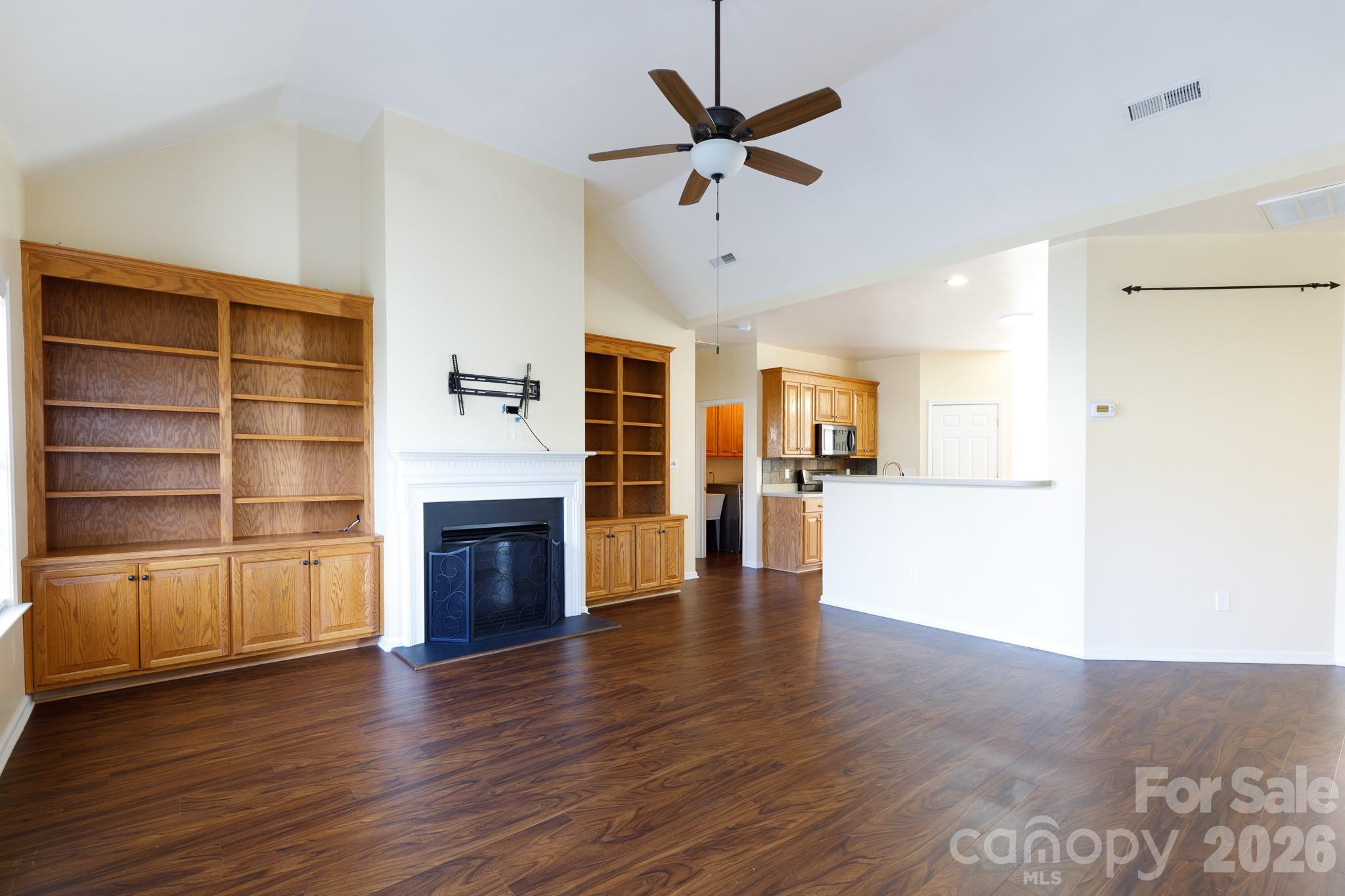 424 Elizabeth Valley Lane Clover, SC 29710 - Photo 12 of 27 a view of a livingroom with a fireplace a ceiling fan and wooden floor
