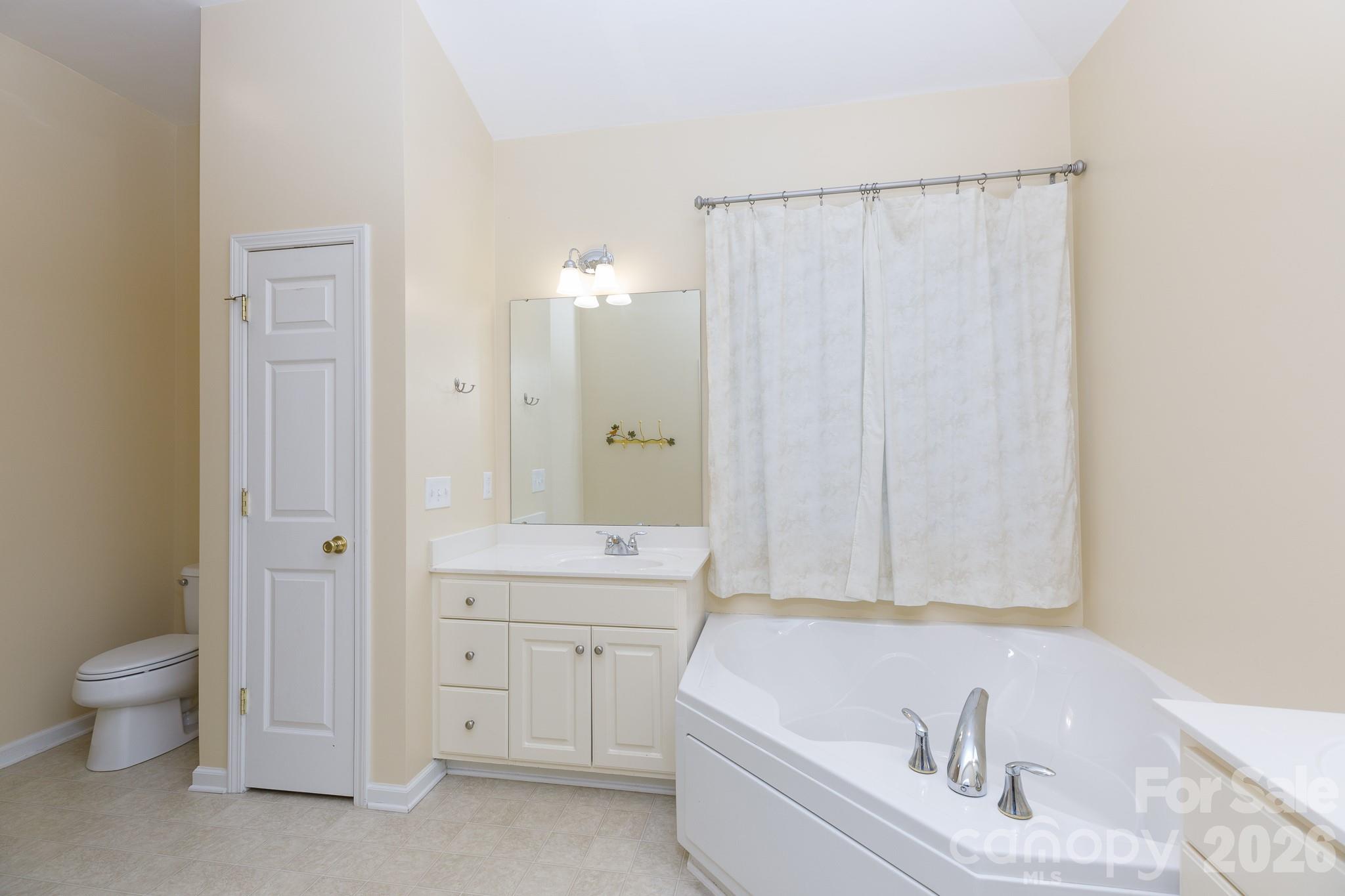 424 Elizabeth Valley Lane Clover, SC 29710 - Photo 16 of 27 a bathroom with a bathtub a toilet and a sink