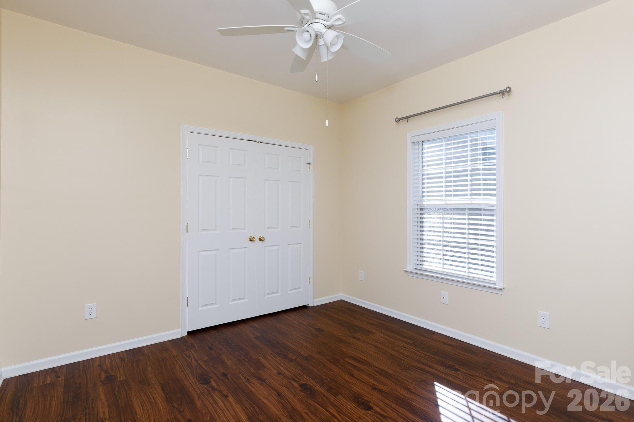 424 Elizabeth Valley Lane Clover, SC 29710 - Photo 19 of 27 a view of an empty room with wooden floor and a window