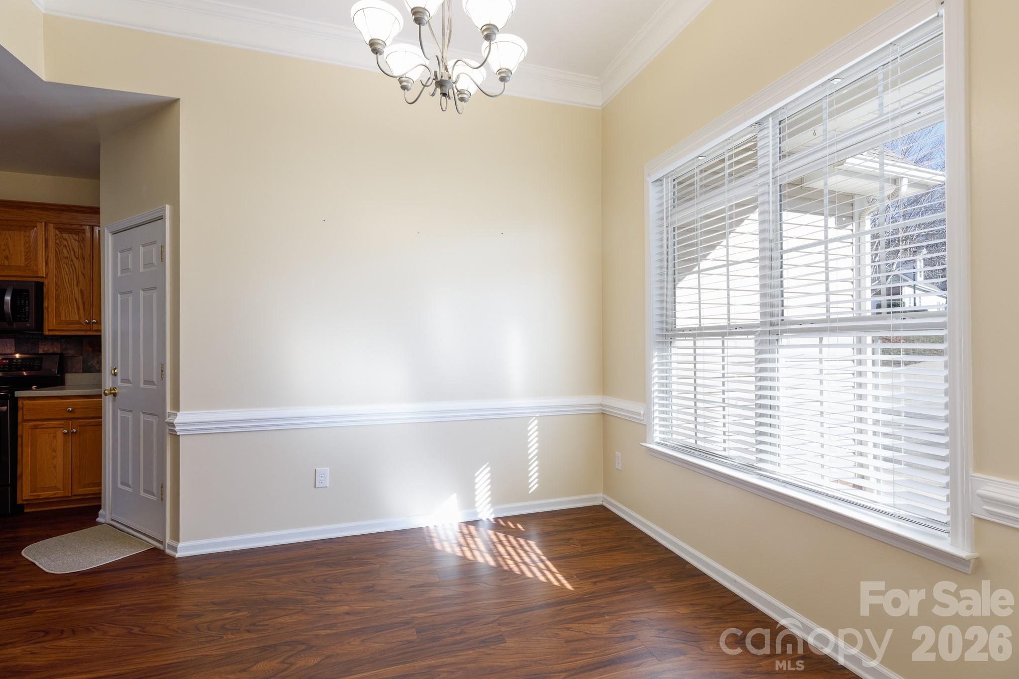 424 Elizabeth Valley Lane Clover, SC 29710 - Photo 6 of 27 a view of an empty room with a window and wooden floor