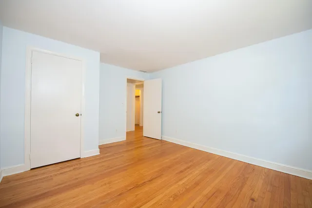 a view of an empty room and wooden floor