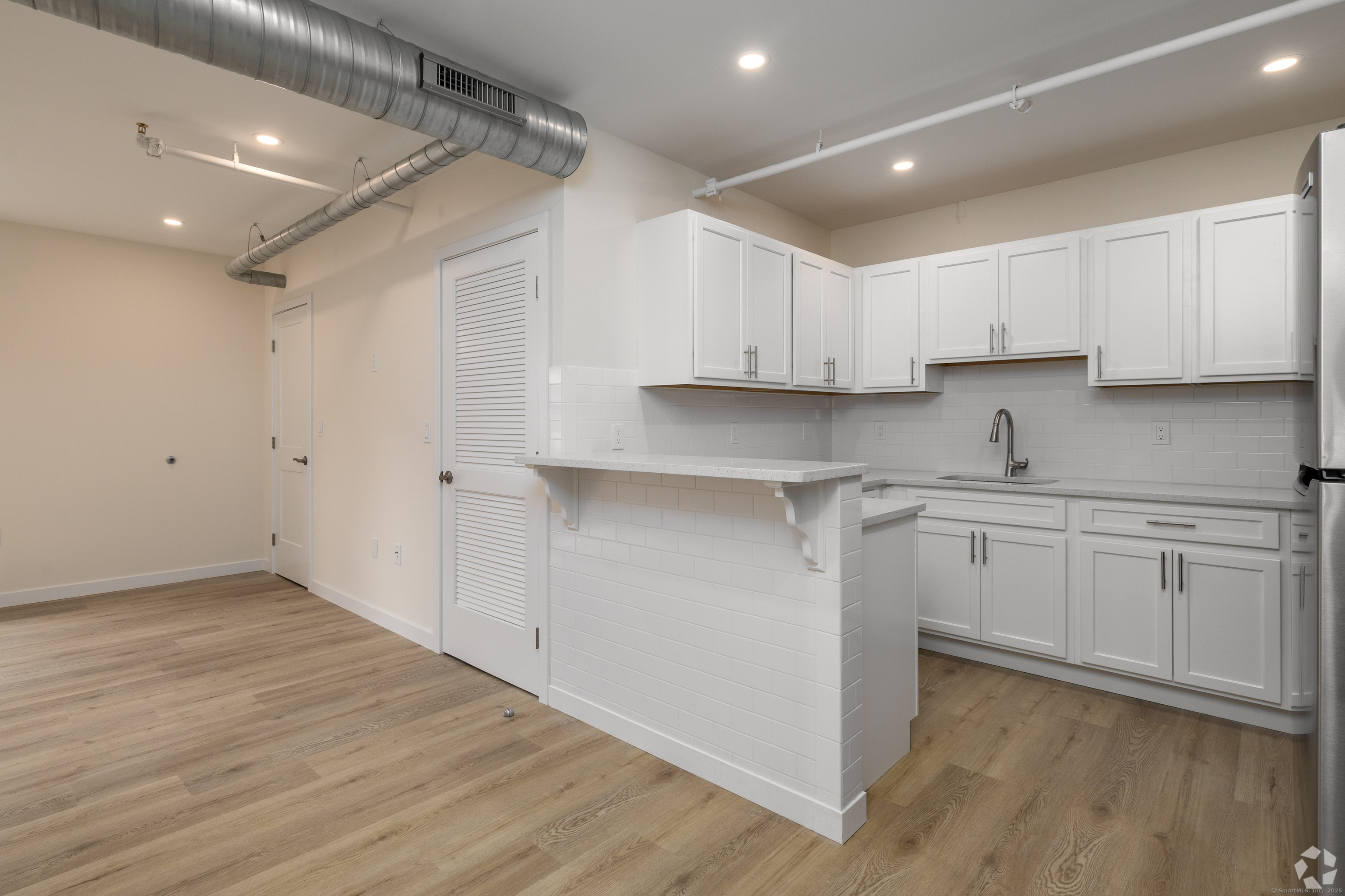 584 Main Street, Unit E Middletown, CT 06457 - Photo 1 of 1 a kitchen with cabinets appliances a sink and a counter top space