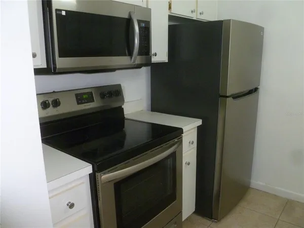 a kitchen with stainless steel appliances white cabinets and a stove