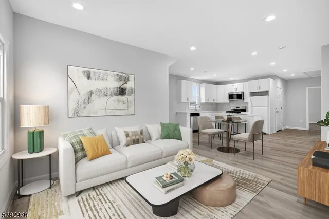 a living room with furniture kitchen view and a table