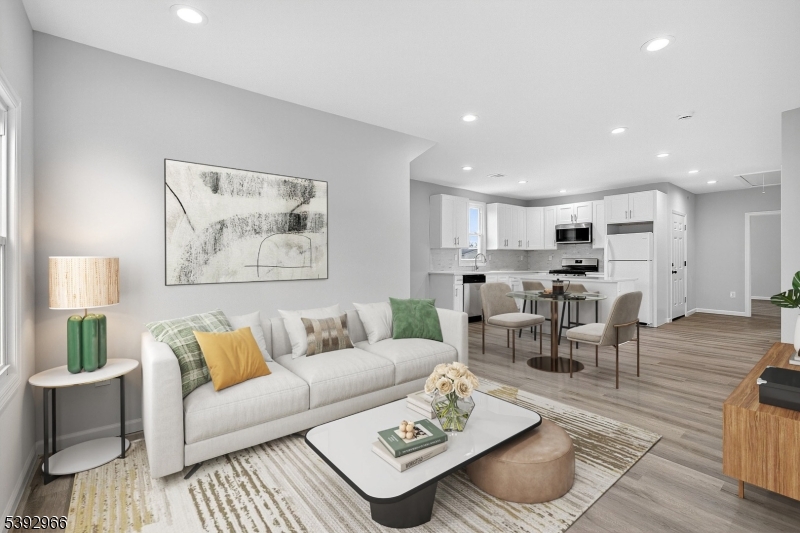 a living room with furniture kitchen view and a table