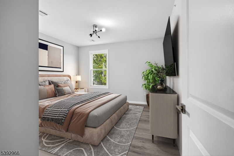 238 Renner Avenue Newark, NJ 07112 - Photo 12 of 30 a bedroom with a bed and a potted plant