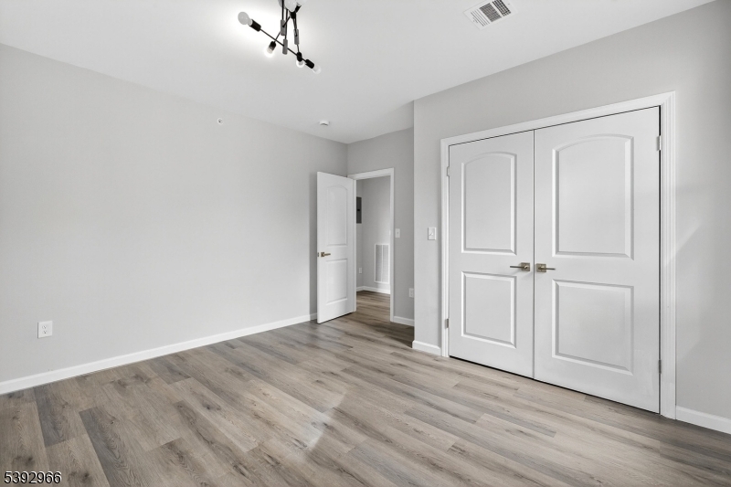 238 Renner Avenue Newark, NJ 07112 - Photo 16 of 30 a view of an empty room with wooden floor