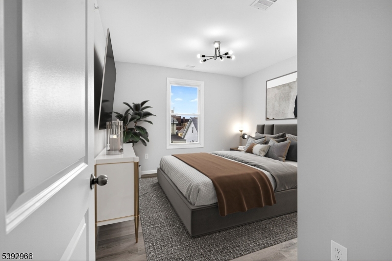 238 Renner Avenue Newark, NJ 07112 - Photo 17 of 30 a bedroom with a bed and a chandelier