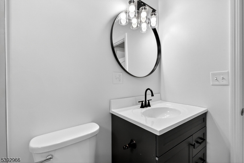 238 Renner Avenue Newark, NJ 07112 - Photo 22 of 30 a bathroom with a sink a toilet and a mirror