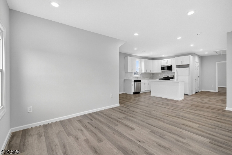 238 Renner Avenue Newark, NJ 07112 - Photo 3 of 30 a view of a kitchen with wooden floor and a window