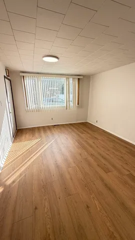 a view of a room with wooden floor
