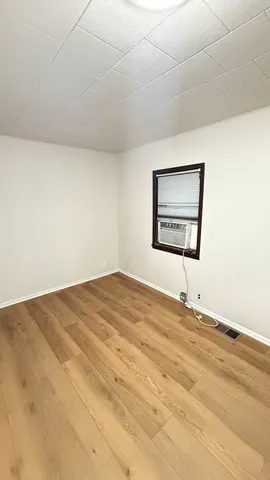 a big room with a bed and a window