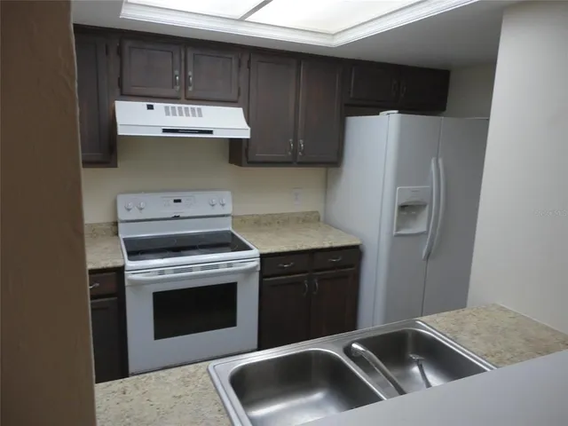 a kitchen with a stove and a refrigerator