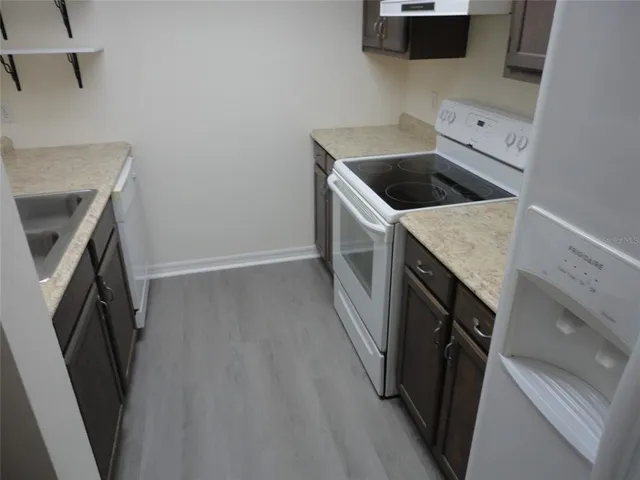 a kitchen with a sink and a washer dryer