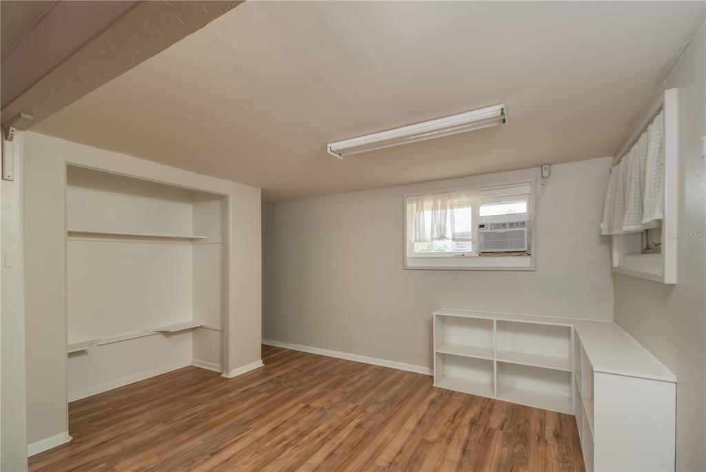15 Ruckert Circle DeLand, FL 32720 - Photo 12 of 61 a view of an empty room with wooden floor and a window