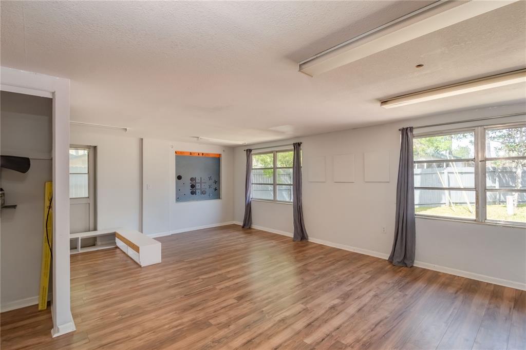 15 Ruckert Circle DeLand, FL 32720 - Photo 15 of 61 a view of empty room with wooden floor and fan