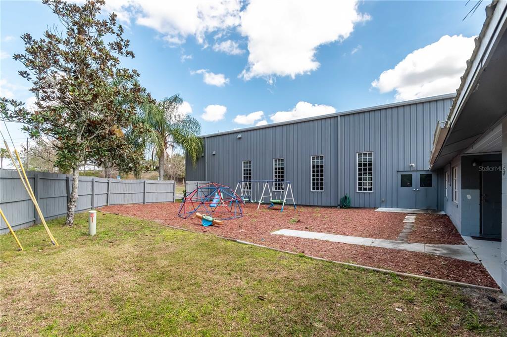 15 Ruckert Circle DeLand, FL 32720 - Photo 17 of 61 a view of a backyard with a slide