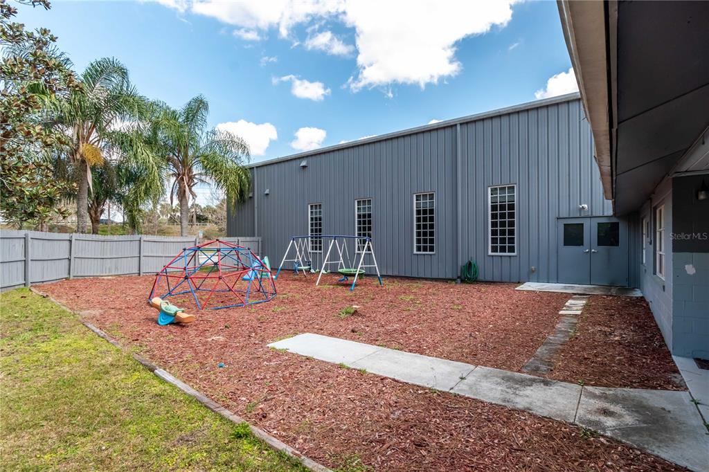15 Ruckert Circle DeLand, FL 32720 - Photo 18 of 61 a backyard of a house with barbeque oven table and chairs