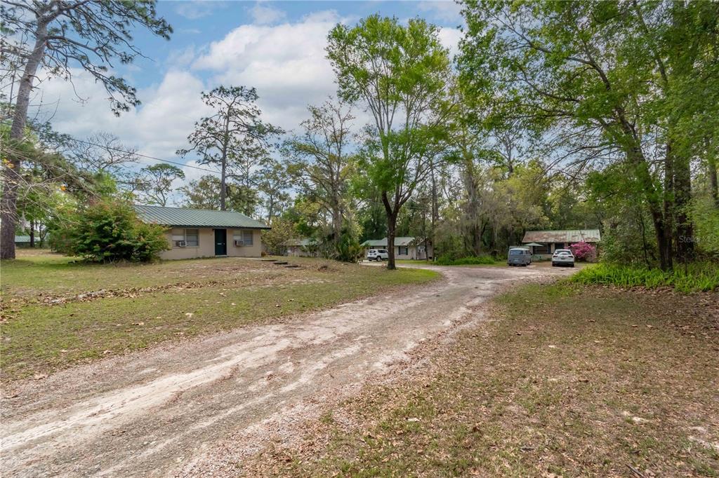 15 Ruckert Circle DeLand, FL 32720 - Photo 24 of 61 a front view of a house with a yard and a car park