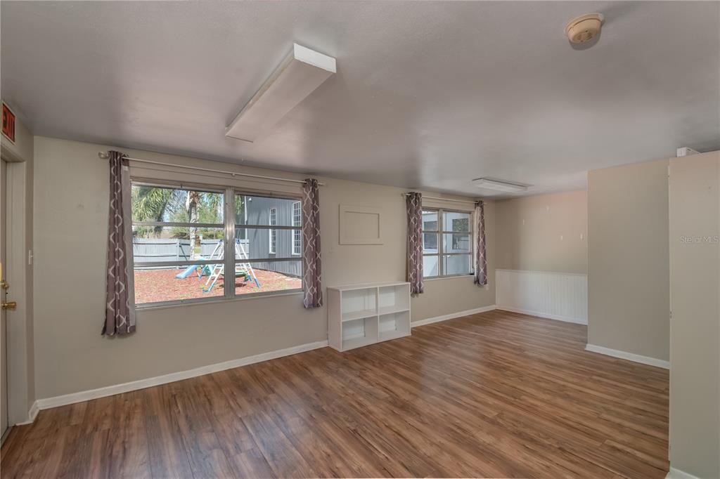 15 Ruckert Circle DeLand, FL 32720 - Photo 40 of 61 an empty room with wooden floor and windows