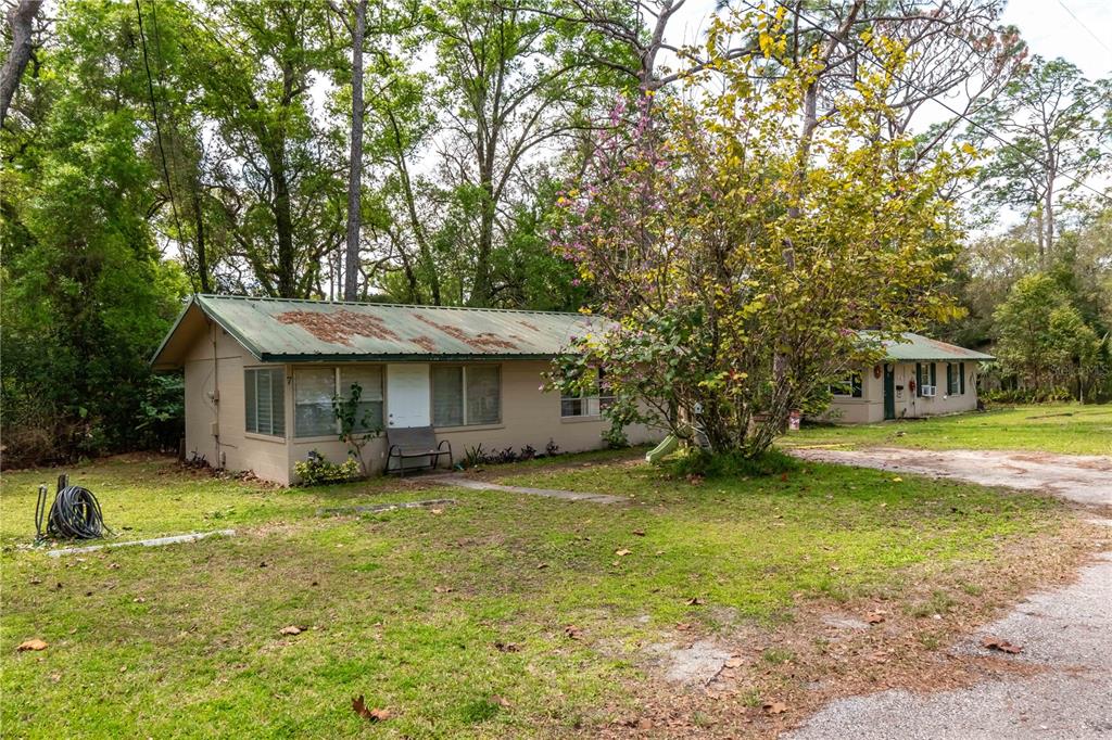15 Ruckert Circle DeLand, FL 32720 - Photo 6 of 61 a view of a house with a big yard and large trees