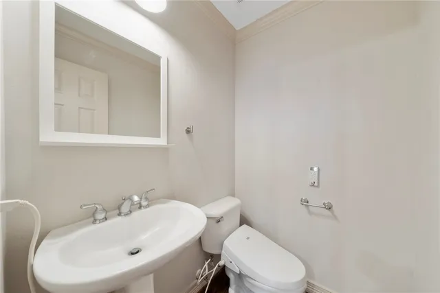 a kitchen with stainless steel appliances granite countertop a sink a stove and white cabinets with wooden floor