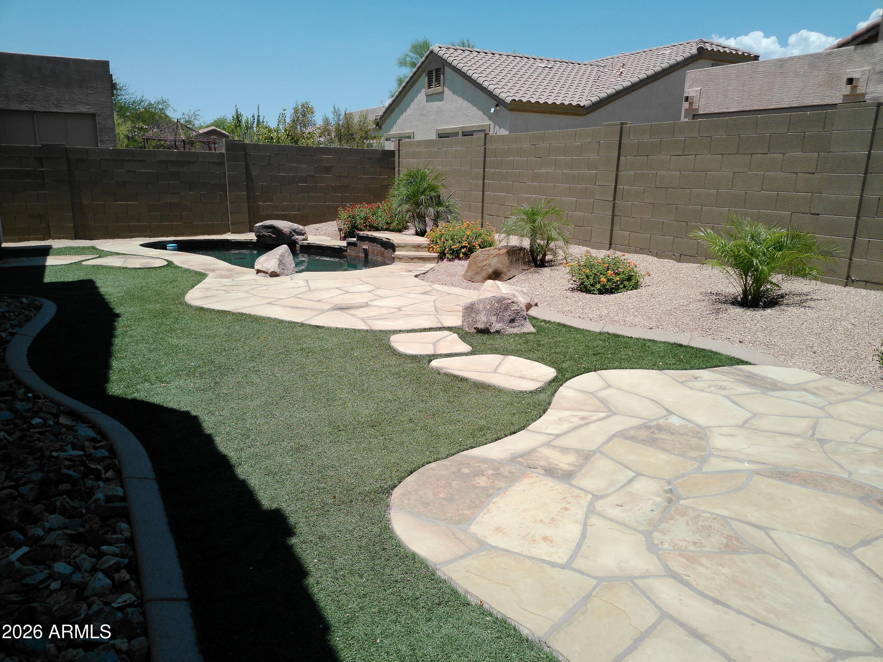 3018 West Sentinel Rock Road Phoenix, AZ 85086 - Photo 6 of 16 a view of a backyard with table and chairs potted plants