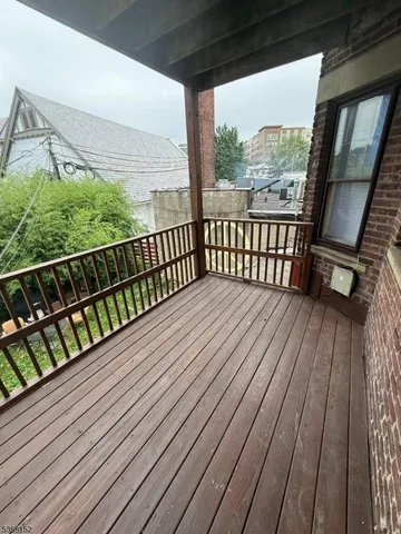 a balcony with wooden floor