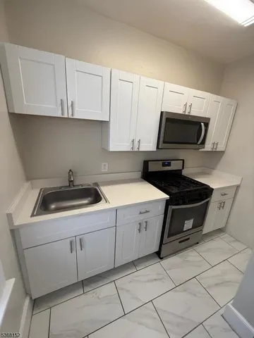 a kitchen with a sink and a stove top oven