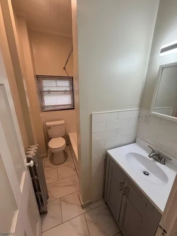 a bathroom with a sink toilet and vanity