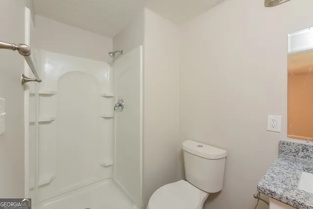 a view of a house with a backyard and a tree