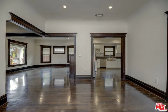 a view of a room with wooden floor
