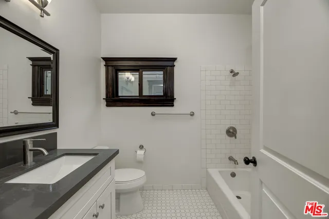 a kitchen with a refrigerator and a sink