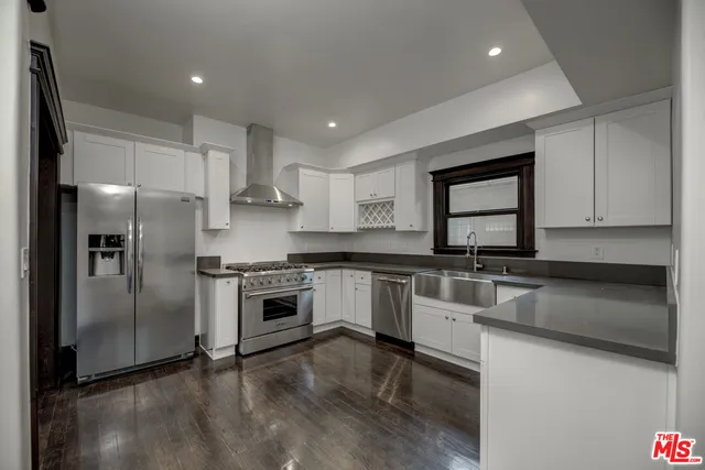 a kitchen with stainless steel appliances granite countertop a sink and a stove