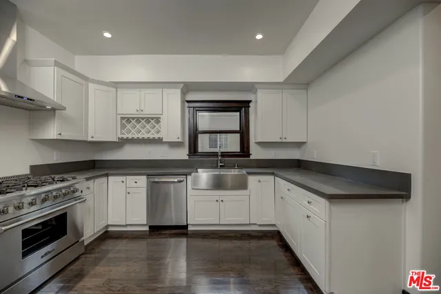 a kitchen with stainless steel appliances granite countertop a stove and a refrigerator