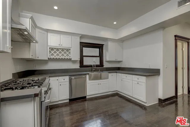 a view of a hallway with wooden floor and closet