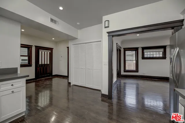a view of washer and dryer with kitchen in the background