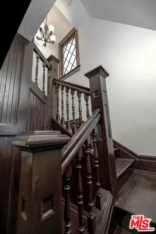 a view of a hallway with wooden floor and closet