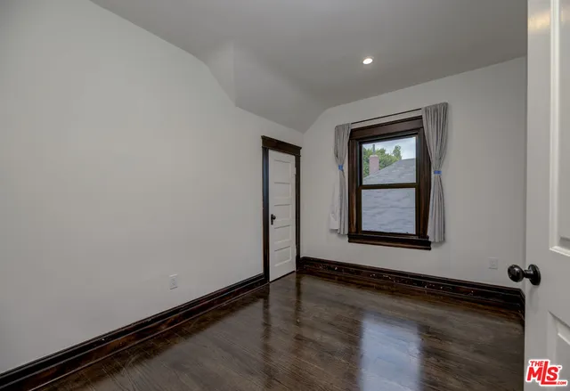 an empty room with wooden floor