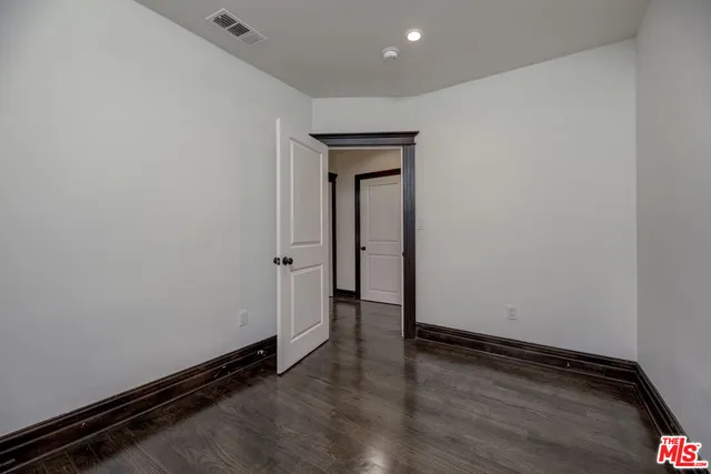 a bathroom with a granite countertop sink a mirror and a bathtub