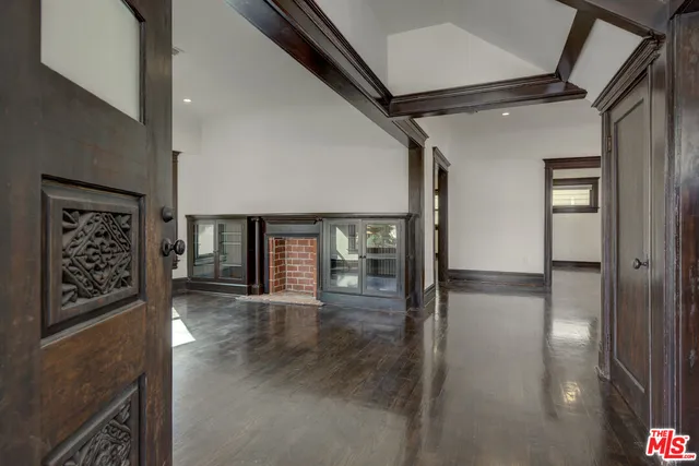 a view of a hallway with wooden floor and dining room
