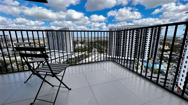 a view of balcony with wooden floor