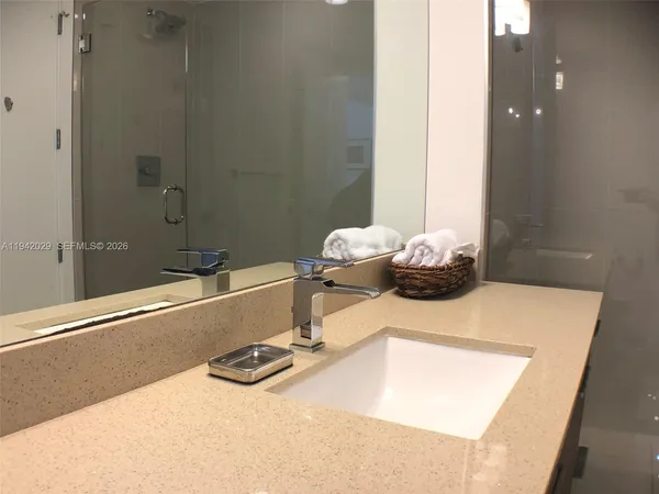 a bathroom with a tub sink and mirror