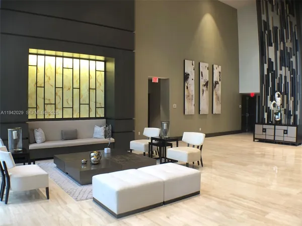 a living room with furniture and large windows