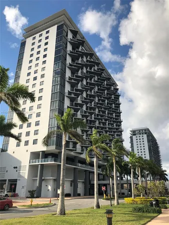 a view of a tall building next to a city view